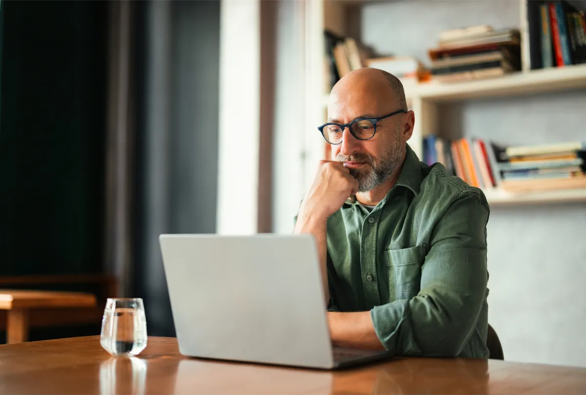 An IT professional reviewing security posture on a laptop in a quiet office