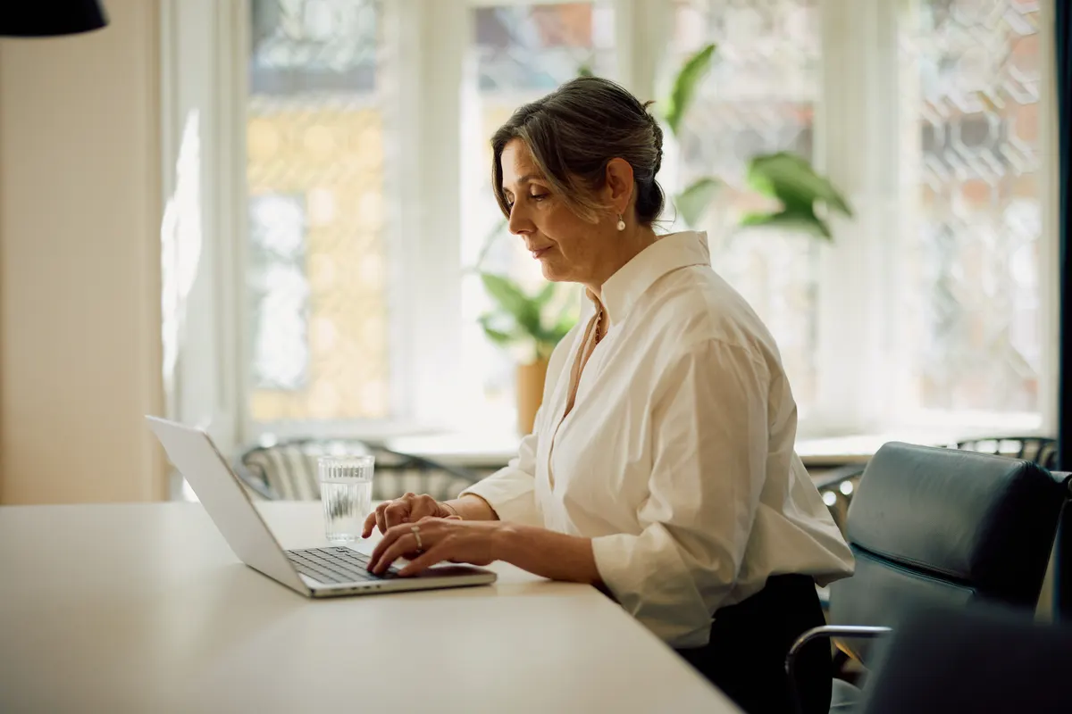 An IT professional reviewing endpoint security and compliance posture on a laptop